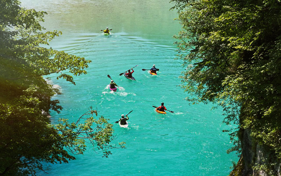 Kayaks on the crystal clear waters of the Soča River